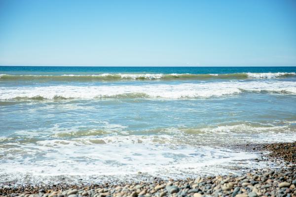 Ocean waves crashing on a pebble beach
