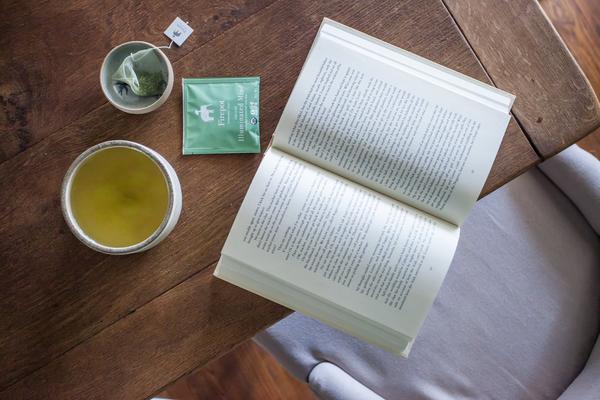 Illuminated Mind matcha green tea on a table with a book
