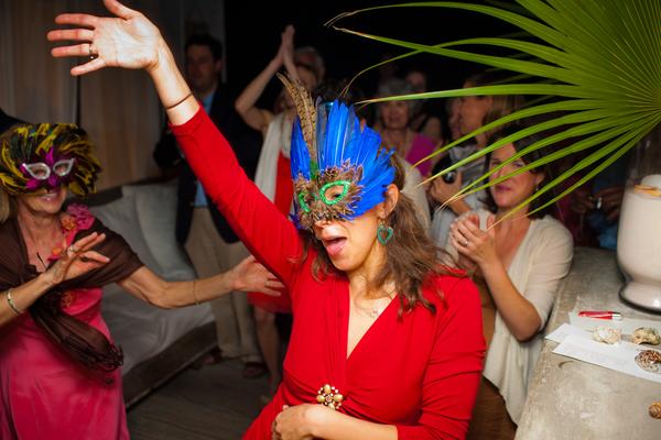 free dancing by woman in red dress with blue feather mask